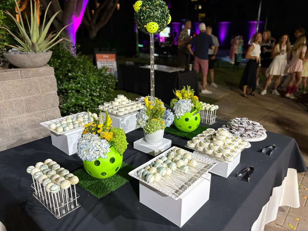 A garden dessert table with cake pops and themed sweets