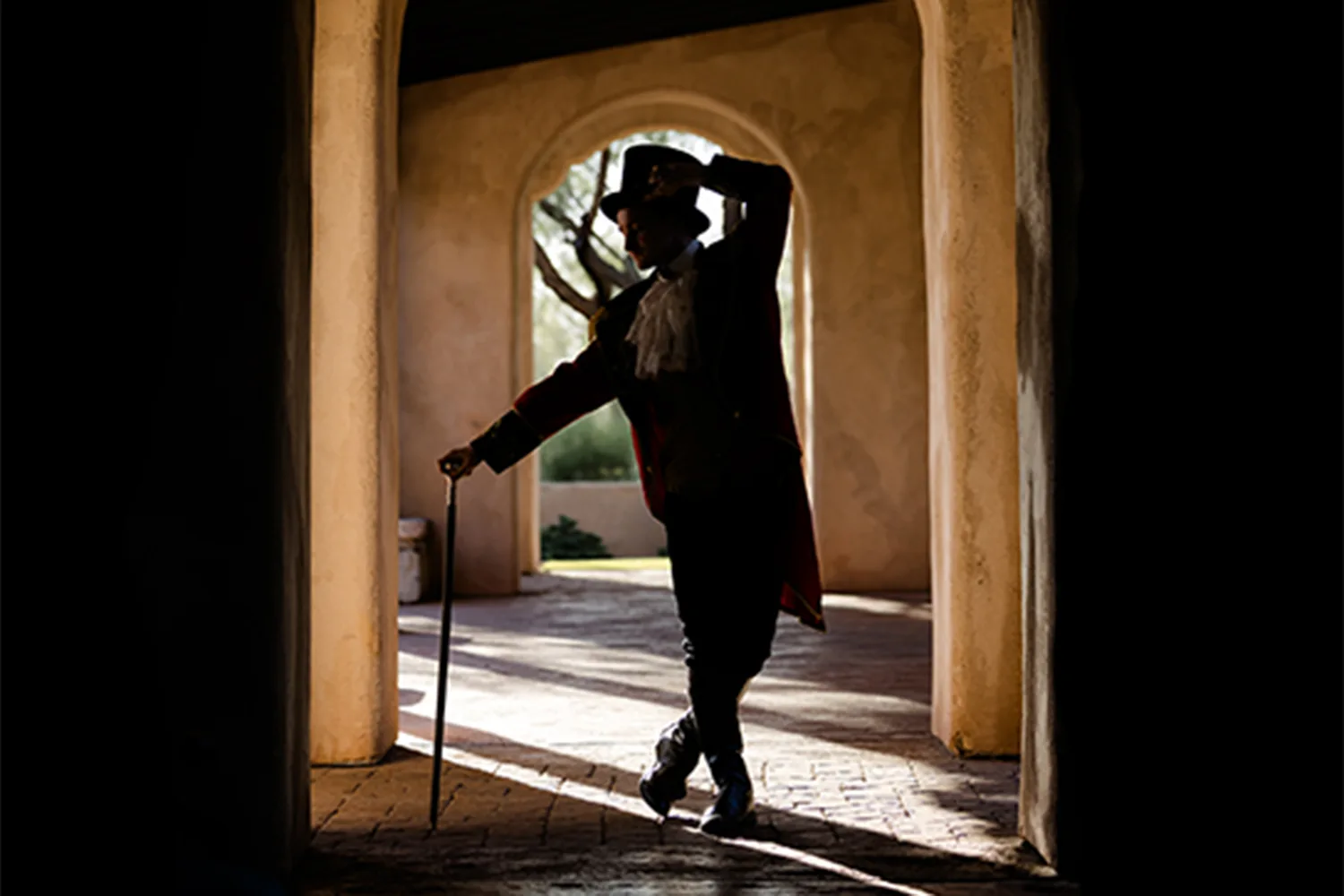 A theatrical showman in dramatic silhouette